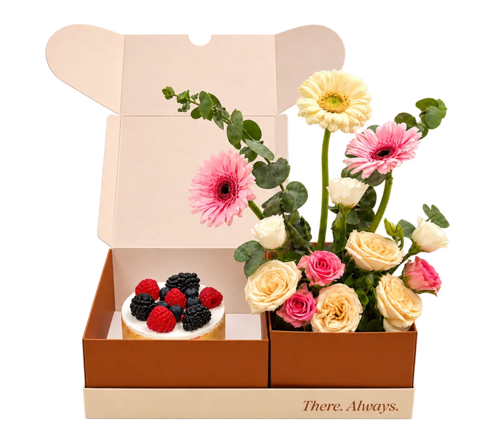 Ganache gift box with a berry cake and a bouquet of fresh flowers